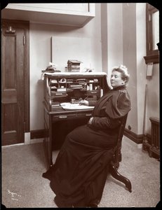 Portrait of an unidentified woman at a desk in an office in New York